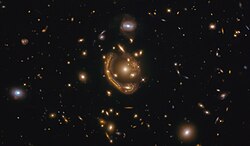 Dubbed the "Molten Ring", Hubble sees strong lensing around GAL-CLUS-022058s.[13]