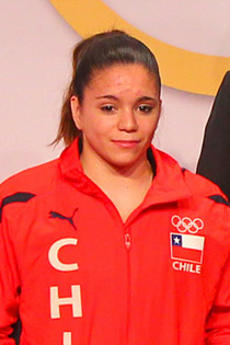 a woman wearing a red shirt with the Olympic rings and the Chilean flag