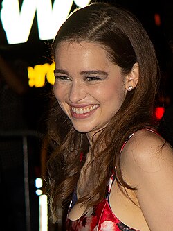A smiling woman looks into the camera