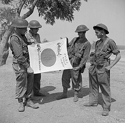 Four soldiers of the British Army's Worcestershire Regiment display a Good Luck Flag captured on Mount Popa during the mop-up operations that took place after the capture of Mandalay.