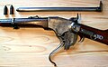 The Spencer repeating rifle with the breech open. Before the breechblock carrier can "roll" downward, the breechblock must fall vertically to clear the receiver.