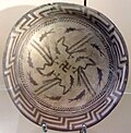 The Samarra bowl, from Iraq, circa 4,000 BCE, held at the Pergamonmuseum, Berlin. The swastika in the centre of the design is a reconstruction.[90]