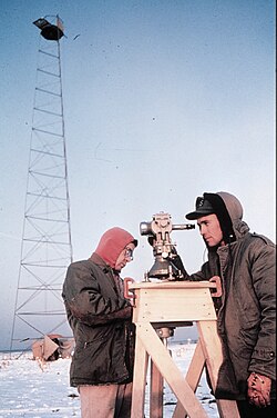 United States Coast and Geodetic Survey technicians observing with a 0.2 arcsecond (≈ 0.001 mrad or 1 μrad) resolution Wild T3 theodolite mounted on an observing stand. Photo was taken during an Arctic field party (c. 1950).