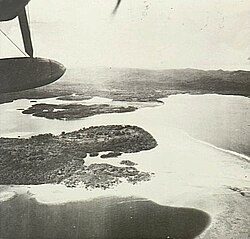 Airplane flying over Gasmata, looking North