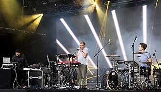 Leftfield performing live in 2016: L-R: Adam Wren, Neil Barnes, Nick Rice (from the band Hadouken!)