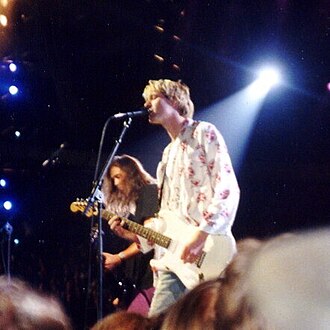 Nirvana performing live at the 1992 MTV Video Music Awards. Kurt Cobain is in the foreground, and Krist Novoselic is in the background.
