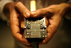 A small metal cube covered in electrical equipment