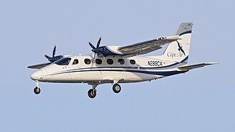 A white and blue twin-engine propeller aircraft