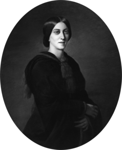 Three-quarter oval portrait of a slender woman aged about 30, garbed in black. Her deep-set eyes gaze solemnly over the viewer's shoulder. Her dark, straight hair is parted in the centre and pulled back in a low bun.