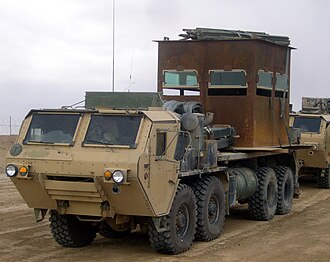 HEMTT M1120A2 with Simula/BAE Systems armoured package in Iraq. Notice the use of M1152 HMMWV armoured glass on the makeshift armoured superstructure.