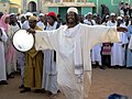 A Sufi dervish drums up the Friday afternoon crowd in Omdurman, Sudan.