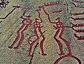 Nordic Bronze Age petroglyph featuring figures holding hammers or axe-like objects among the Tanum rock carvings, Sweden