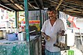 A man in Kolkata, with a chaidaani for carrying nine glasses of chai – plain tea without masala