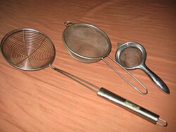Several wire meshes shaped like bowls, with metal handles.