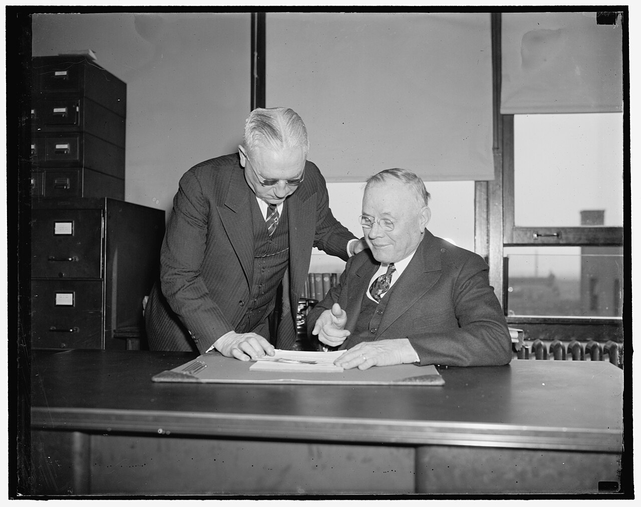 At A.F. of L. meeting. Washington, D.C., April 19. William Green, President of the American Federation of Labor, and Daniel J. Tobin, (standing) Vice President, held a last minute confab LCCN2016871571.jpg