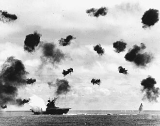 Aircraft carrier USS Yorktown hit by an aerial torpedo during the Battle of Midway