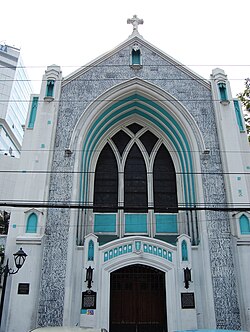 A church exterior that is gray and teal (Central United Methodist Church)