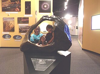 Children posing behind a replica of the Tucson Meteorite at the Arizona Museum of Natural History[29]