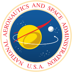 A blue sphere with stars, a yellow planet with a white moon; a red chevron representing wings, and an orbiting spacecraft; surrounded by a white border with "NATIONAL AERONAUTICS AND SPACE ADMINISTRATION U.S.A." in red letters.