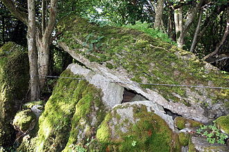 Moss-covered upright stones supporting a massive leaning stone roof slab