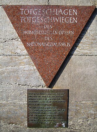 Pink triangle plaque honouring gay victims, a subway station in Berlin.