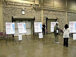 Several posters are shown in a public meeting held for the Red and Purple Modernization Project.