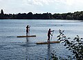 Two lifeguards of the DLRG patrolling a public bathing area of the Fasaneriesee in summer 2022