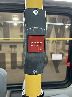 A picture of a red stop button on a city bus operated by Niagara Transit.