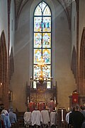 Evangelical-Lutheran acolytes kneel during High Mass at Holy Trinity Church in Uppsala on the Feast Day of the Apostles Philip and James the Less