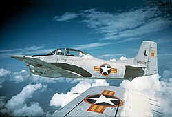 photo of a North American T-28A-NA Trojan fighter plane, taken from another T-28 on its wing, they are both high above the clouds