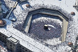 Aerial view of the largest mosque in the world, The Sacred Mosque (Al-Masjid Al-Ḥarām) of Mecca in the Hejaz region of Saudi Arabia, with the Kaaba in the center
