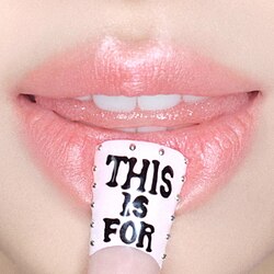 A woman's pink lips with a nail reading "THIS IS FOR"