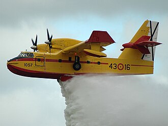 Canadair CL-215 extinguishing fire, with a bright yellow livery  