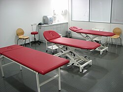 Massage room with three red massage tables