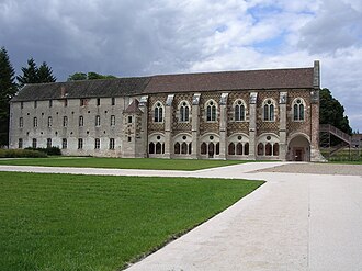photograph of a grand brick and stone building and its lawns