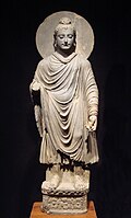 The Buddha wearing kāṣāya robes, originating from ancient India. Fully ordained Buddhist monks and nuns wore these robes.