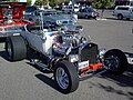T-bucket with early hemi, but aluminum radiator (rather than brass), rectangular headlights, and five-spokes (rather than motorcycle wheels) mark this as a later incarnation