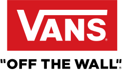 Storefront with large "VANS" sign and display windows showing shoes