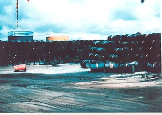 Stacks of 200 L (44 imp gal; 53 US gal) drums containing Agent Orange.