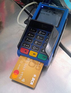 Castles Technology payment terminal with BCA Debit Mastercard card inserted