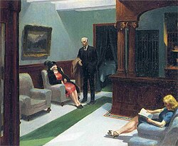 A man and two women sit in a hotel lobby with stark lighting and subdued tones