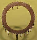 A bracelet made of brass, beads and mother of pearl