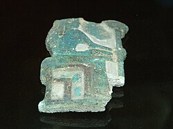 Fragmentary relief of green glaze showing a woman seated