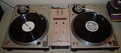 Two vinyl turntables and a small mixer