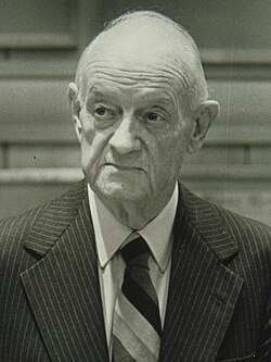 A picture of newspaper publisher John S. Knight, holding a folded up newspaper under his left armpit