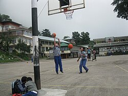 Schoolgirls shooting hoops among the Himalayas in Dharamsala, India