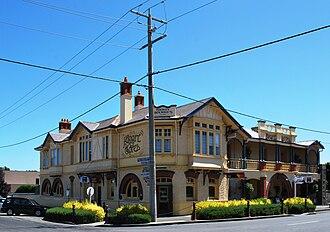 Koroit Hotel. The signpost at the right of the picture gives distances to faraway towns in Ireland.