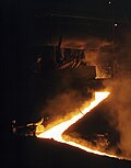 Molten slag flowing into a channel, exiting a Martin-Siemens converter in 1941
