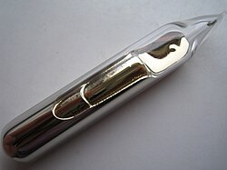 Some pale gold metal, with a liquid-like texture and lustre, sealed in a glass ampoule