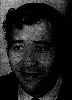 Black-and-white headshot of a suited Talbot gazing away from the viewer